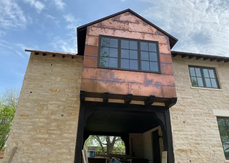 Copper metal panel facade on a stone building for Skylight Installation in Indian River Estates