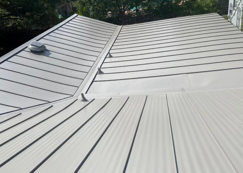 Solar attic fan installed on a metal roof for Roof Ventilation in Indian River Estates